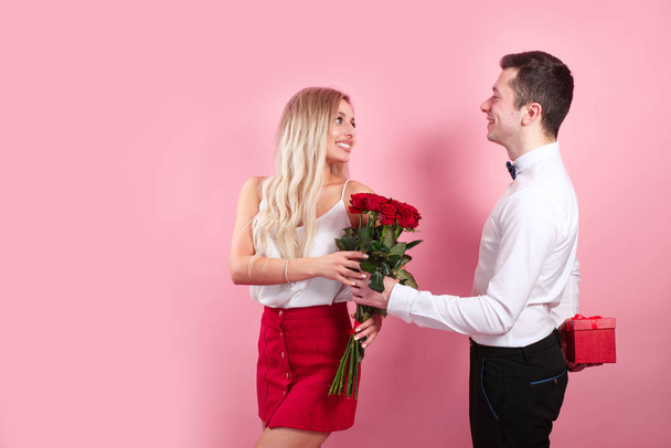 happy man make a surprise with flowers and gift box for a girlfriend - Foto, Imagen