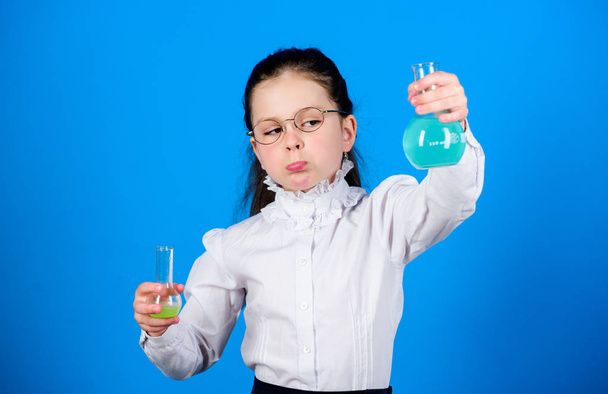 science research in lab. Small school girl. child study bilogy lesson. back to school. education and knowledge. small smart girl with testing flask. Testing samples. Concentrated on cure - Фото, зображення