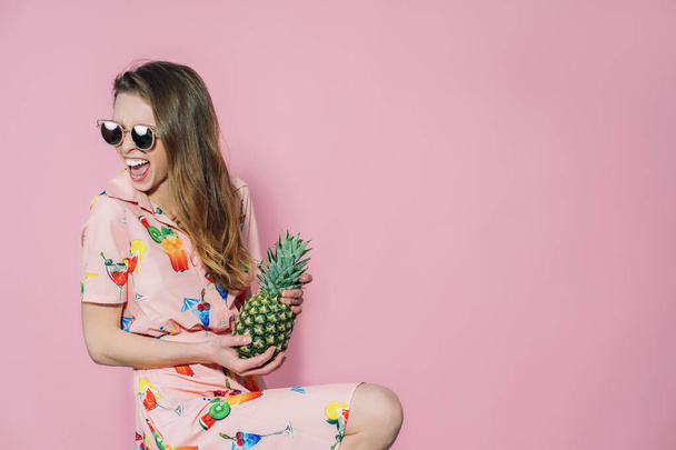 Pineapple in ladys hands. Trendy and stylish fashion. - Фото, изображение