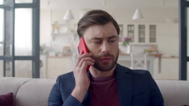 Focused businessman discussing business on phone. Guy feeling doubt. - Záběry, video