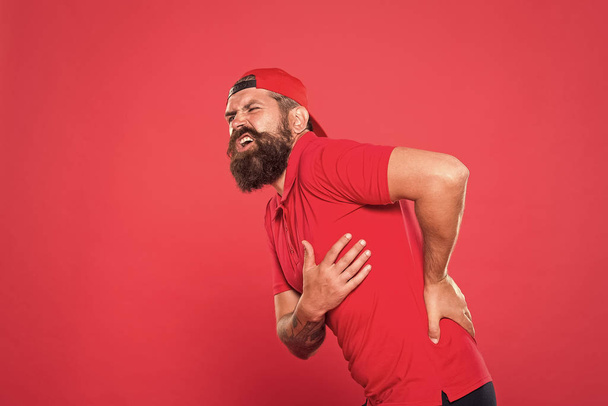 My back hurts. bearded man pain in back. barista tired and back pain after work. need massage. health care concept. barber feel hurt. terrible ache in spine. problems with health. exercises for back - Fotoğraf, Görsel