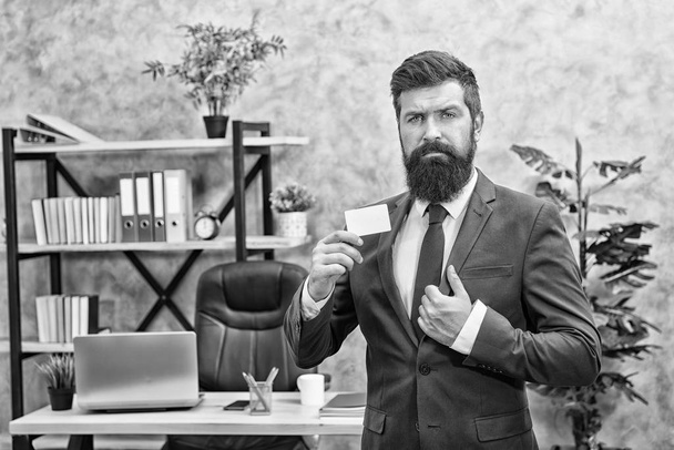 Banking services for small business. Card design. Call now. Guy formal suit stand in office. Accountant or banker. Businessman hold blank card. Useful contacts. Bearded hipster top manager show card - Foto, Imagen