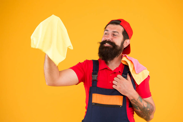 After construction cleaning services. Let light into your home. Man brutal cheerful bearded worker wiping dust rag. Cleaning supplies concept. Easy cleaning tips. Guy work with piece of cloth - Photo, Image