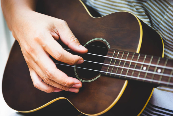 Closeup of guitarist hand playing guitar. Musical instrument con - Foto, Imagem