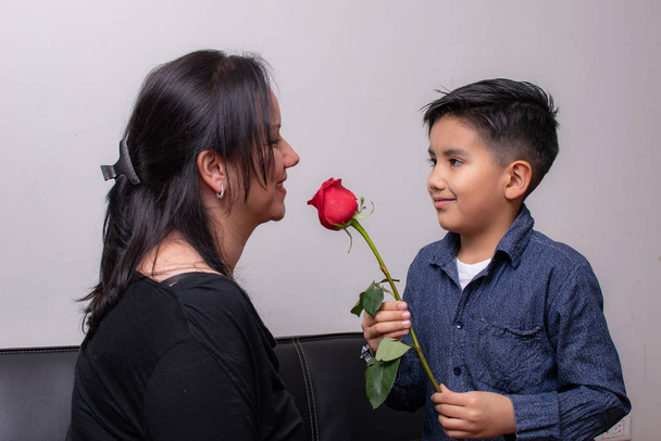 boy gives a rose to his Colombian mom on mothers day - Photo, Image