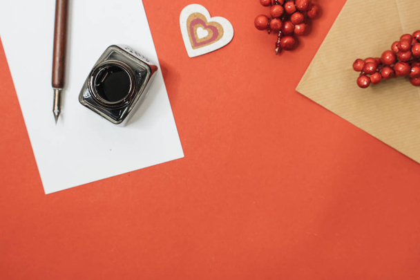 Set of vintage dip pen, inkpot and blank paper sheet with envelope on red, Valentines day concept - Φωτογραφία, εικόνα