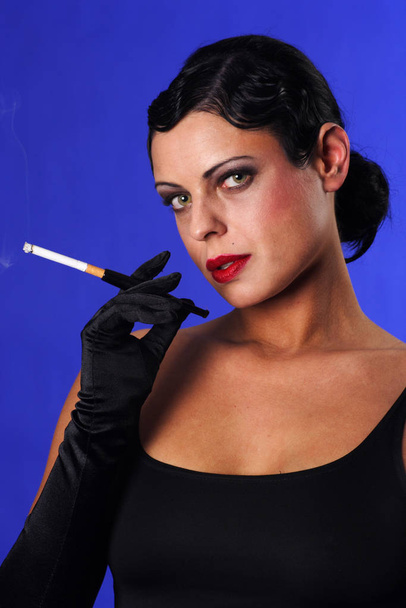 a woman in 20s style smoke,and in color - Φωτογραφία, εικόνα
