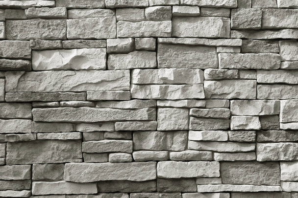 Vista frontal de la pared de piedra rugosa gris monótono para el fondo
 - Foto, imagen