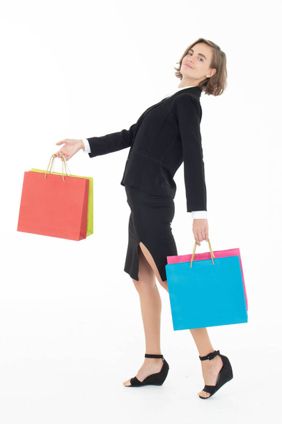 Portrait of young business woman holding shopping bags on white  - Photo, Image