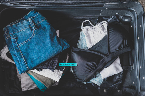 luggage with pile of clothes and Packing Everything label on the - Φωτογραφία, εικόνα