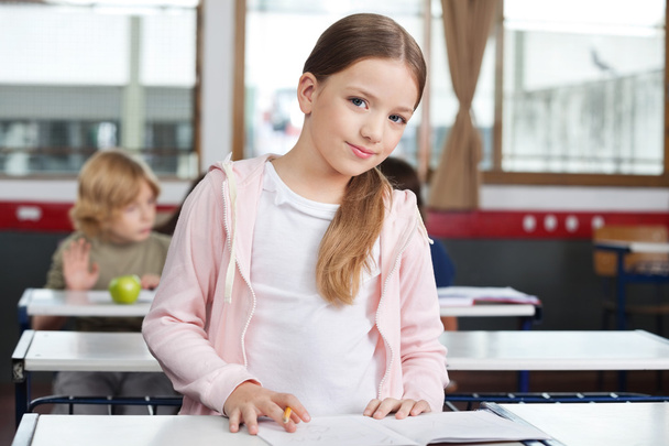 Little Girl Studying While Standing At Desk - Fotoğraf, Görsel