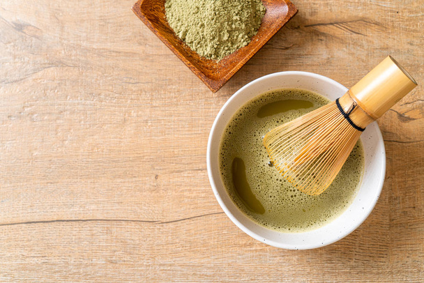 hot matcha green tea cup with green tea powder and whisk - Фото, зображення