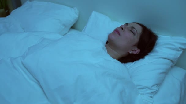Young woman having nightmare, tossing in bed at night, post-traumatic stress - Metraje, vídeo