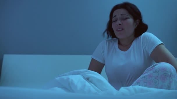 Sick woman rubbing tummy, suffering sharp stomach pain at night, indigestion - Filmati, video