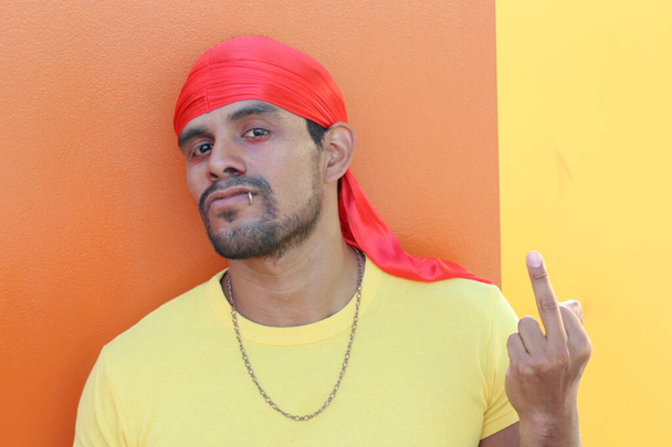 Ethnic man with 1980s rapper style showing middle finger - Photo, Image