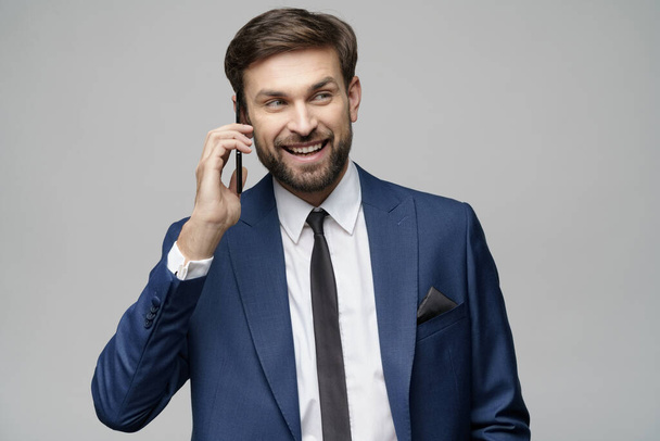businessman talking on the phone isolated over grey background - Foto, Imagem