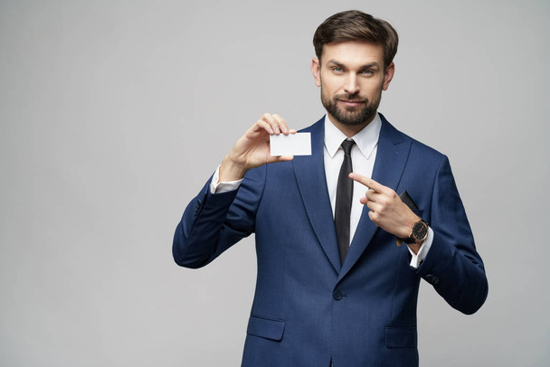 young handsome businessman holding business or credit card - Foto, immagini