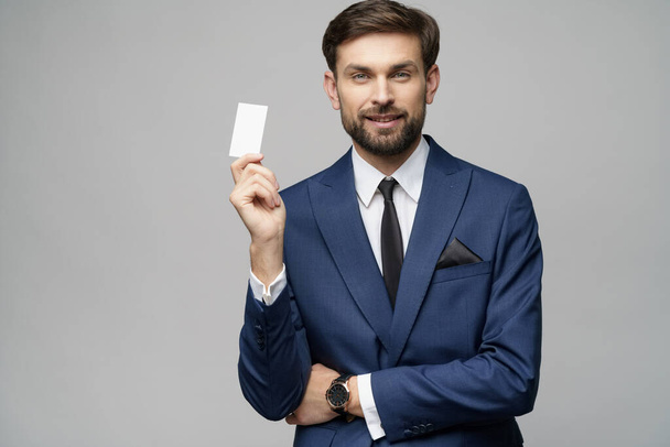 young handsome businessman holding business or credit card - 写真・画像