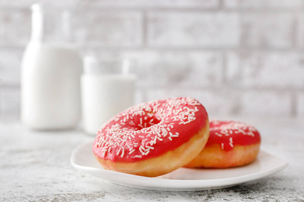 Plate with sweet tasty donuts on table - Photo, image