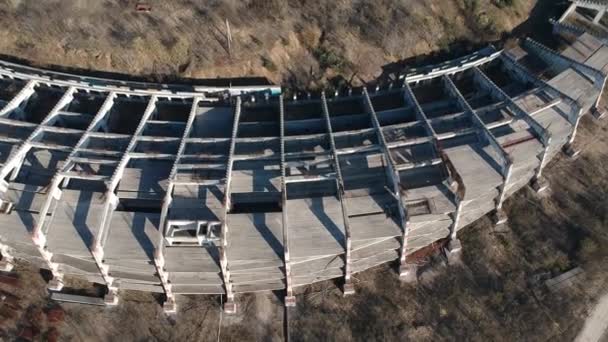 Abandoned derelict  unbuilt stadium construction ruins in city, aerial view - Video, Çekim