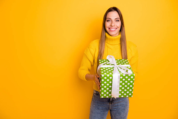Portrait of cheerful positive girl celebrate christmas time party get big green white dotted present box feel content emotions wear knitted jumper denim jeans isolated shine color background - Photo, Image
