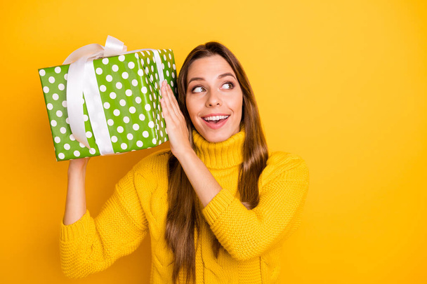 Interesting what is it. Amazed funky teen girl get big giftbox with white ribbon for anniversary she wait all life wear casual style jumper isolated over bright color background - Foto, Imagem