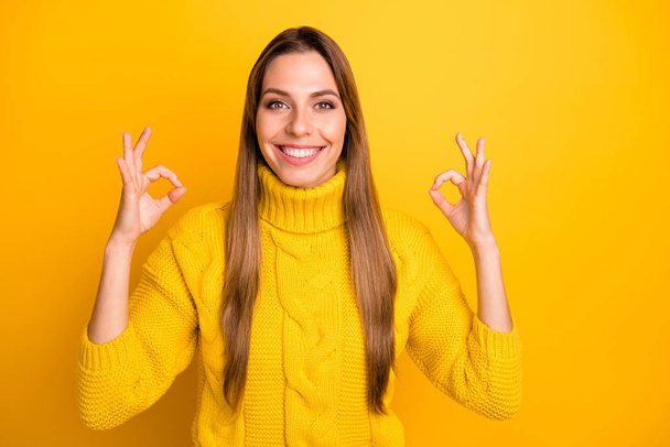 Portrait of positive cheerful girl promoter show okay sign recommend ad advertise promotion wear vivid jumper isolated over yellow color background - Foto, Imagem