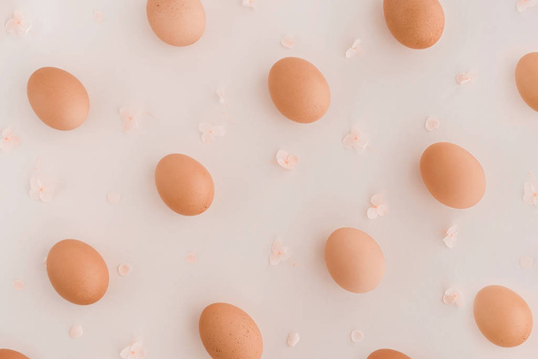 Easter eggs pattern with hydrangea flowers on beige background. - 写真・画像