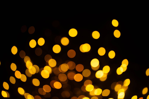 Bright golden glitter festive background. Abstract shimmering circles decorative backdrop. Bokeh lights with shiny effect. Overlapping glowing and twinkling spots - Φωτογραφία, εικόνα
