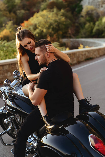 Couple of lovers kissing and hugging on motorbike - Photo, image