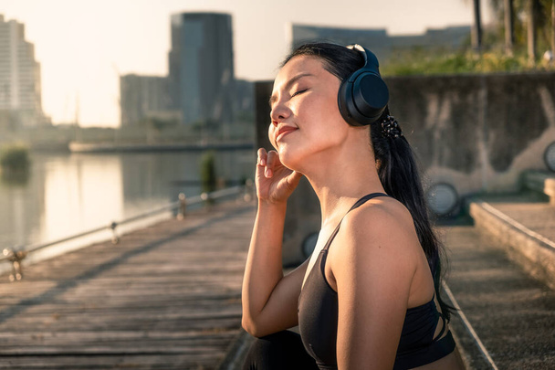 Mujer relajante y escuchando música con auriculares
 - Foto, Imagen