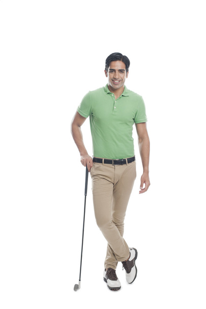 Male golfer standing with a golf club - Foto, afbeelding