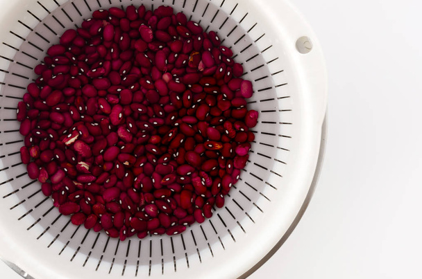 Red kidney beans, beans soaked in water before cooking, in Colander with Stainless steel bowl - Photo, Image