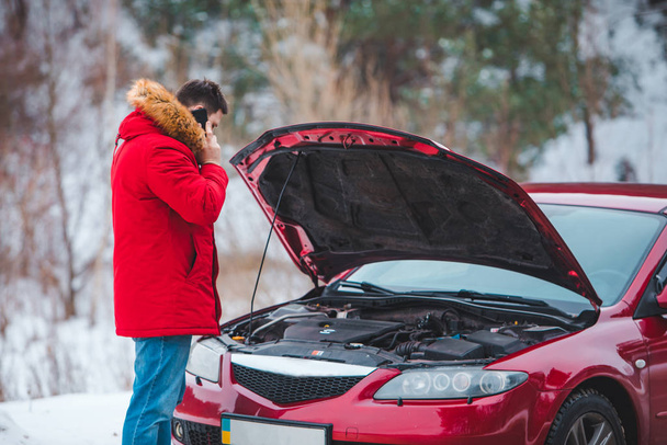 man standing near broken car with opened hood calling help - Photo, Image