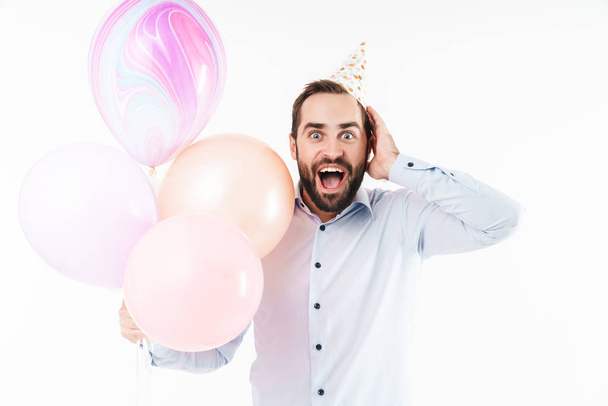 Image of optimistic party man screaming and holding air balloons - Fotoğraf, Görsel