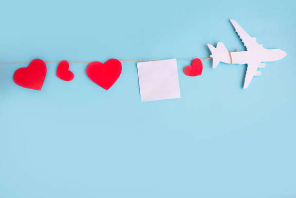 toy airplane on blue table with red heart - Foto, Imagem