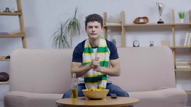 worried sport fan touching scarf and watching championship  - Footage, Video