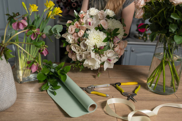 education in the school of floristry. Master class on making bouquets. Summer bouquet. Learning flower arranging, making beautiful bouquets with your own hands. Flowers delivery - 写真・画像
