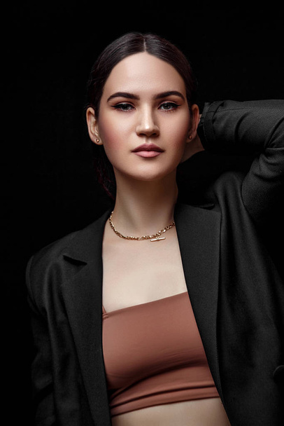 High fashion portrait of young elegant woman in black suit and b - Foto, Bild