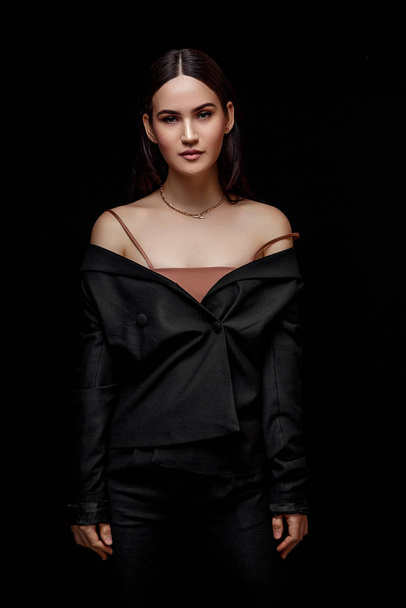 High fashion portrait of young elegant woman in black suit and b - Фото, зображення