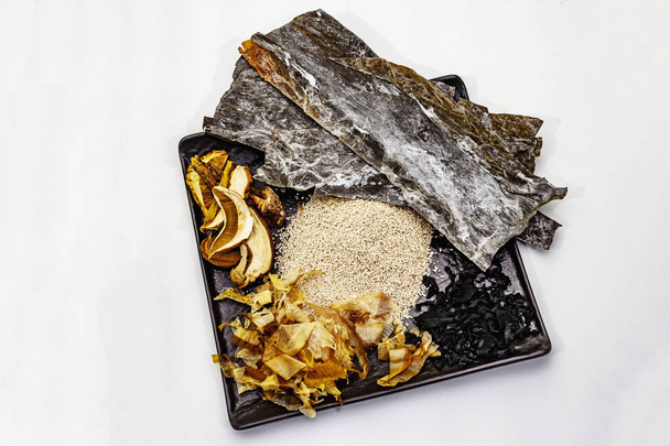 Set traditioneller japanischer Zutaten zum Kochen grundlegender Dashi-Brühe. Algen Kombu und Wakame, Katsuobushi und Trockenpilze. isoliert auf weißem Hintergrund - Foto, Bild
