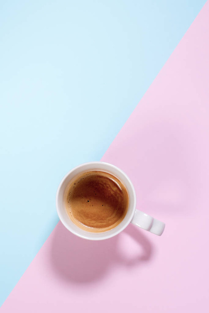 Fresh one cup espresso coffee with milk on pastel - 写真・画像