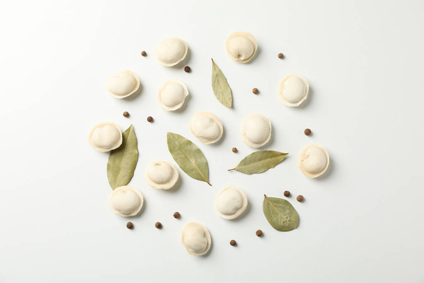 Raw dumplings and spices on white background, space for text - Valokuva, kuva