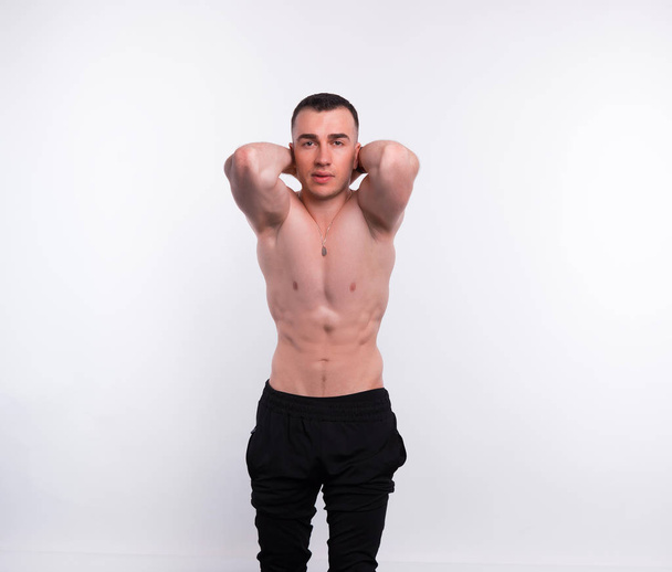 Photo of fitness young man posing over white background - Photo, Image