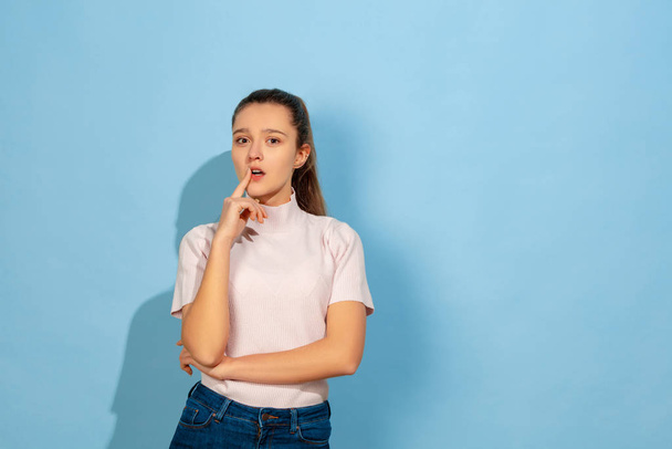 Caucasian teen girl portrait isolated on blue studio background - Foto, Imagem