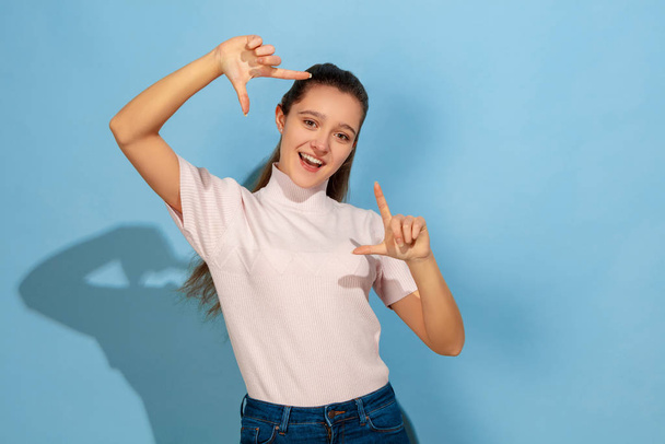 Caucasian teen girl portrait isolated on blue studio background - Fotoğraf, Görsel