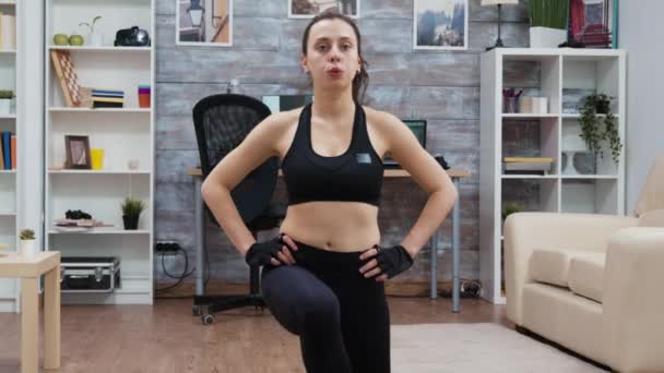 Woman using bodyweight to do lunge workout - Filmati, video