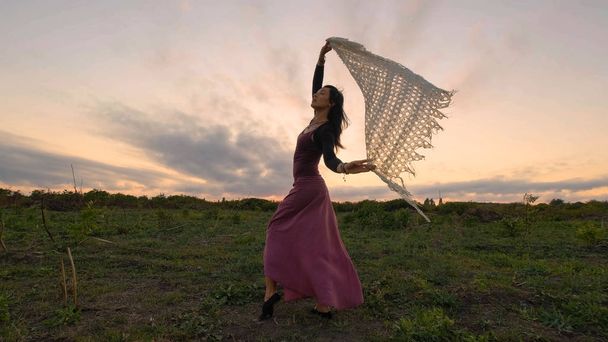 Happy female dance in the summer fields during beautiful sunset - Photo, Image