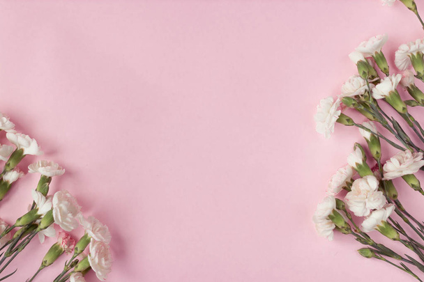 Flowers on a pink background. Top view - Zdjęcie, obraz