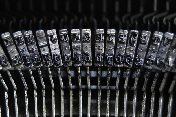 Letters and numbers in the typo keys of a old qwerty typewriter - Fotoğraf, Görsel